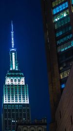 Low angle view of skyscrapers lit up at night
