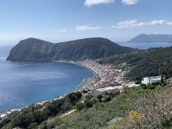 High angle view of townscape by sea against sky