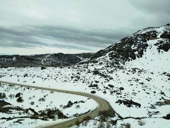 Scenic view of snow covered mountains against sky