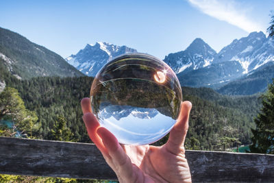 Close-up of hand holding crystal ball