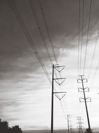 Low angle view of electricity pylon against sky