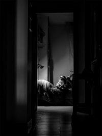 Woman reading book while lying on bed at home