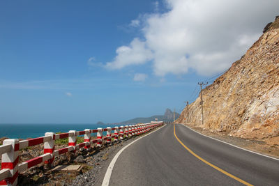 Road by sea against sky