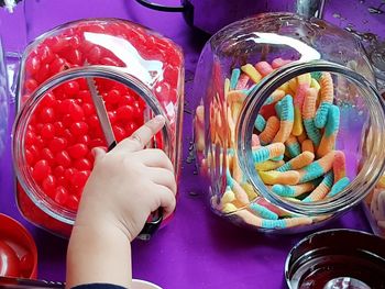 Close-up of hand holding ice cream in jar