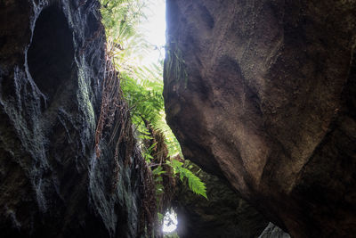 Low angle view of cave against sky