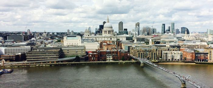 View of cityscape against cloudy sky