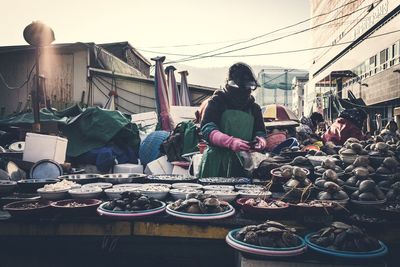 People working at market stall