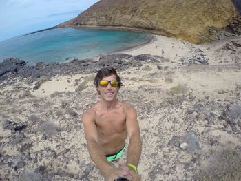 Man taking selfie with monopod at beach