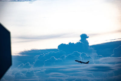 Low angle view of airplane flying against sky