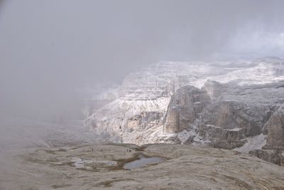 Aerial view of rock formation against sky during winter