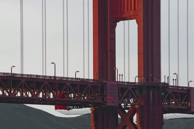 Bridge in city against sky during sunset