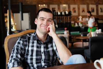 Portrait of smiling man sitting at restaurant