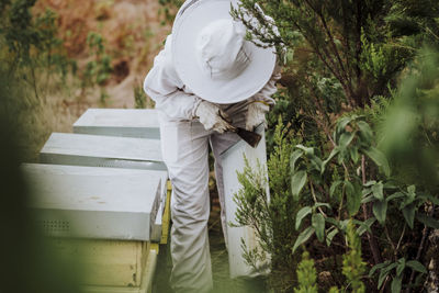 A young woman beekeeper working