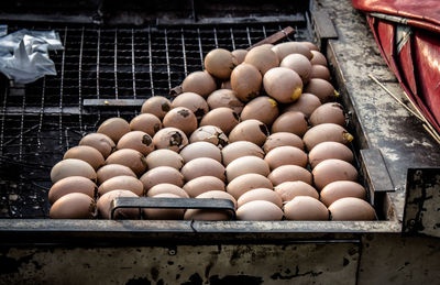 High angle view of eggs on barbecue grill at market