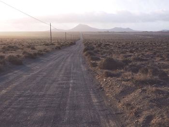 Road amidst landscape against sky