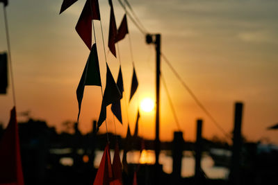 Close-up of silhouette rope against sky during sunset