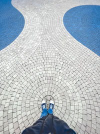 Low section of man standing on swimming pool