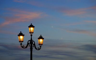 Low angle view of street light against sky