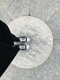 Low section of man standing on tiled floor