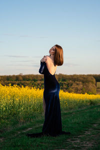 Full length of woman standing on field