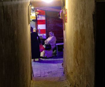 Side view of people sitting in restaurant at night