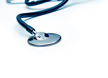 Close-up of electric lamp on table against white background
