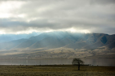 Scenic view of mountains against cloudy sky