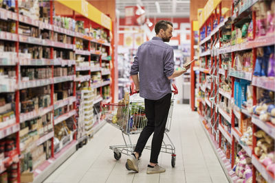 Man doing shopping in supermarket