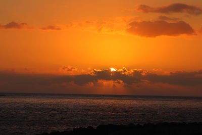 Scenic view of sea against romantic sky at sunset