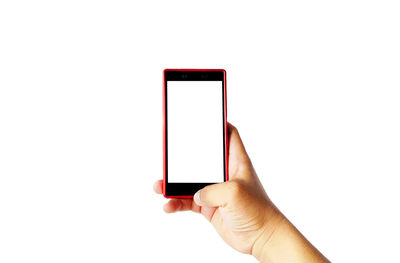 Midsection of person holding mobile phone against white background