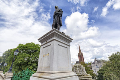 Low angle view of statue against sky