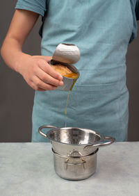 Pouring oil from a tin can with preserved food, box  tuna fish, processed ingredients, feeding  pet
