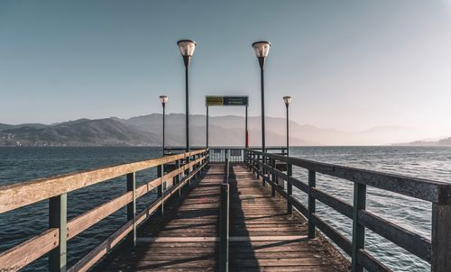 Pier over sea against clear sky