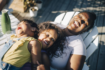 High angle view of daughters and mother in backyard