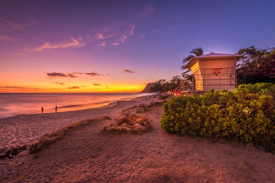 Scenic view of beach against sky during sunset