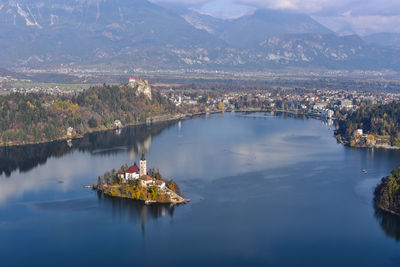 High angle view of lake by mountain against sky