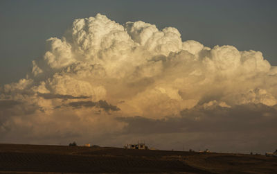 Panoramic view of agricultural field against sky