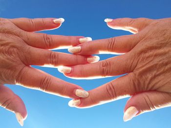 Close-up of cropped hands against blurred background