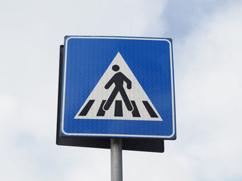 Low angle view of road sign against sky