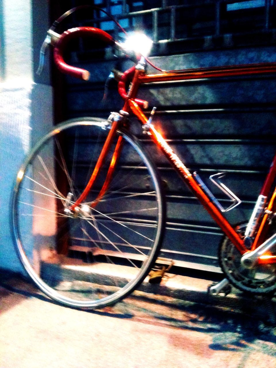 mode of transport, transportation, land vehicle, bicycle, stationary, headlight, illuminated, car, night, street, parking, wheel, reflection, parked, close-up, travel, no people, focus on foreground, outdoors, glass - material