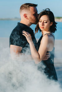 Young couple kissing in water