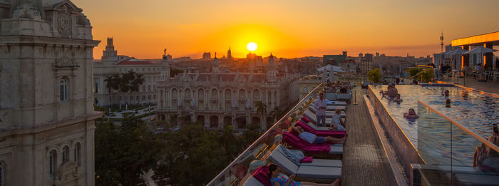 High angle view of buildings in city during sunset