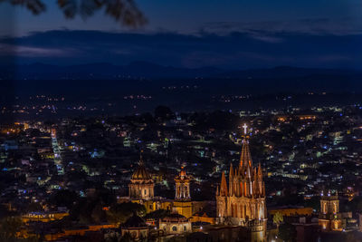 High angle view of illuminated buildings in city at night