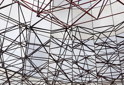 Image shows an abstract celling metal construction on blue sky background