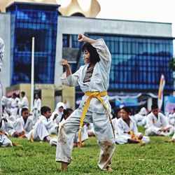 Girl practicing karate on field