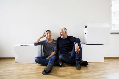 Mature couple relaxing after moving into their new house