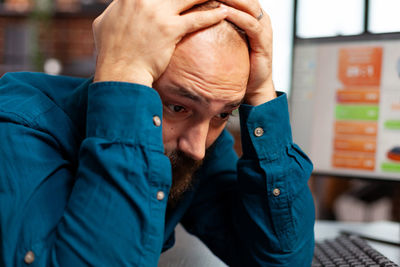 Worried businessman sitting in office