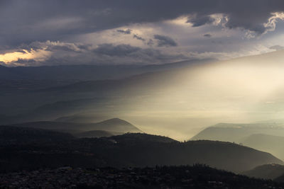 Scenic view of mountains against sky at sunset