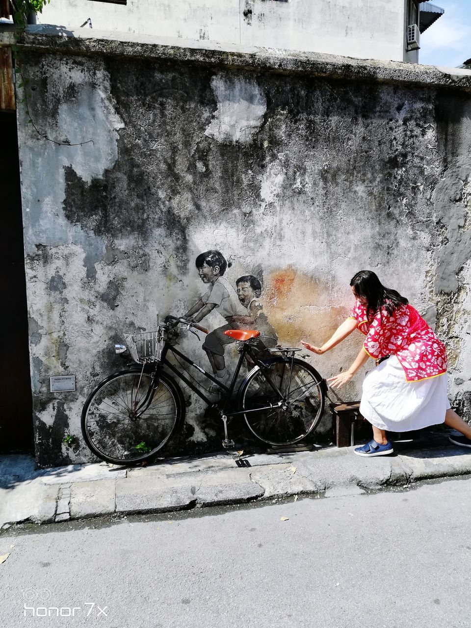 SIDE VIEW OF PEOPLE SITTING ON BICYCLE