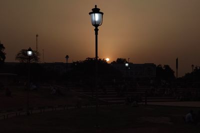 Street lights in city at sunset